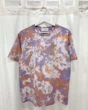 Load image into Gallery viewer, A hand dyed tie dye organic cotton t-shirt featuring a peach and purple color scheme, displayed on a hanger.